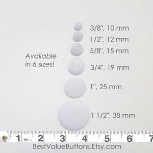 May include: White fabric-covered buttons in six sizes, ranging from 3/8 inch (10 mm) to 1 1/2 inches (38 mm). The image includes text that says "Available in 6 sizes!" and "BestValueButtons.Etsy.com".