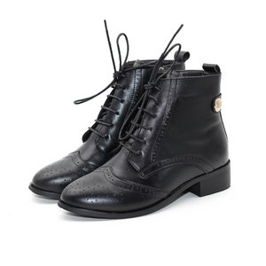 May include: Black leather ankle boots with lace-up closure and a brogue design. The boots have a low block heel and a decorative gold button on the side.