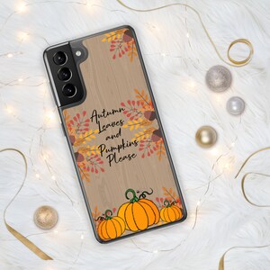 May include: A clear phone case featuring a wooden background design with the text "Autumn Leaves and Pumpkins Please." The case is decorated with orange pumpkins and fall foliage.
