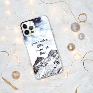May include: A clear phone case with a snowy mountain scene and a cloudy sky. The text "Your Custom Bible Verse/Text Here" is printed on the case.