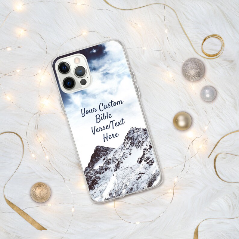 May include: A clear phone case with a snowy mountain scene and a cloudy sky. The text "Your Custom Bible Verse/Text Here" is printed on the case.