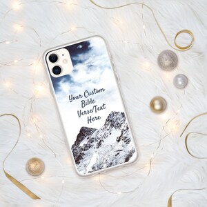 May include: A clear phone case with a mountain and cloudy sky design. The text "Your Custom Bible Verse/Text Here" is printed on the case.