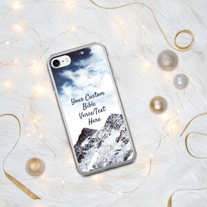 May include: A clear phone case with a snowy mountain scene and a blue sky. The text "Your Custom Bible Verse/Text Here" is printed on the case.