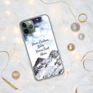 May include: A clear phone case with a snowy mountain scene and a cloudy sky. The text "Your Custom Bible Verse/Text Here" is printed on the case.