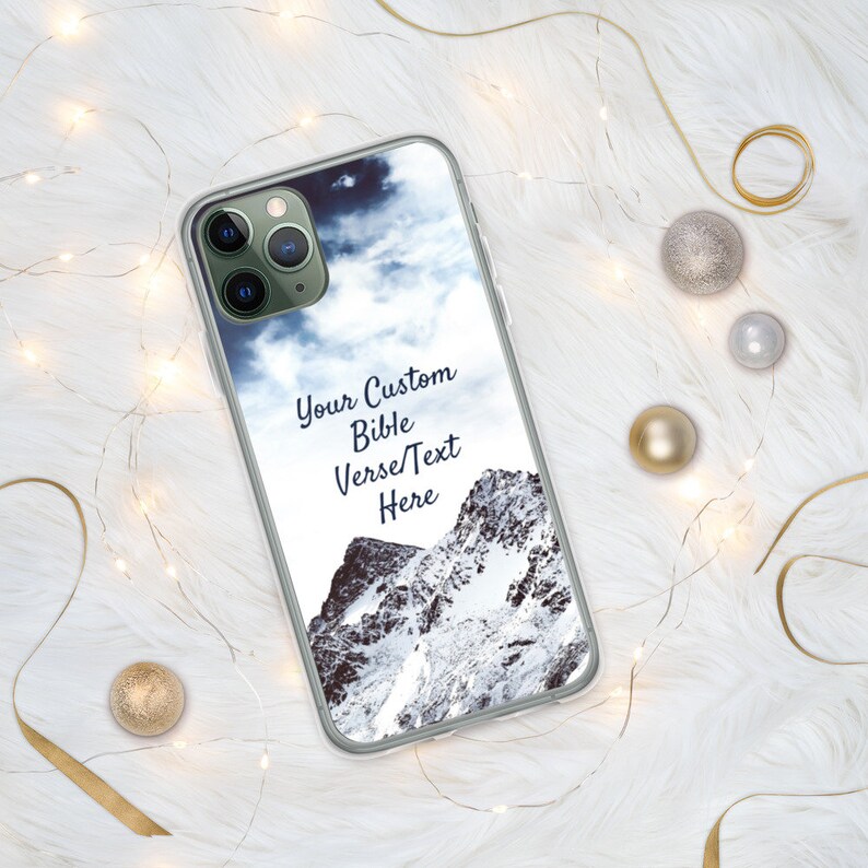 May include: A clear phone case with a snowy mountain scene and a cloudy sky. The text "Your Custom Bible Verse/Text Here" is printed on the case.