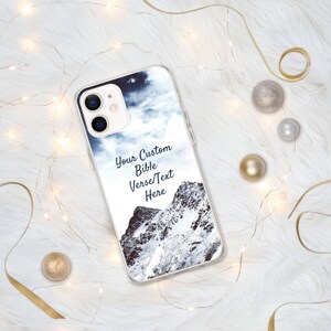May include: A clear phone case with a snowy mountain scene and the text "Your Custom Bible Verse/Text Here".