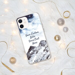 May include: A clear phone case with a snowy mountain scene and the text "Your Custom Bible Verse/Text Here".