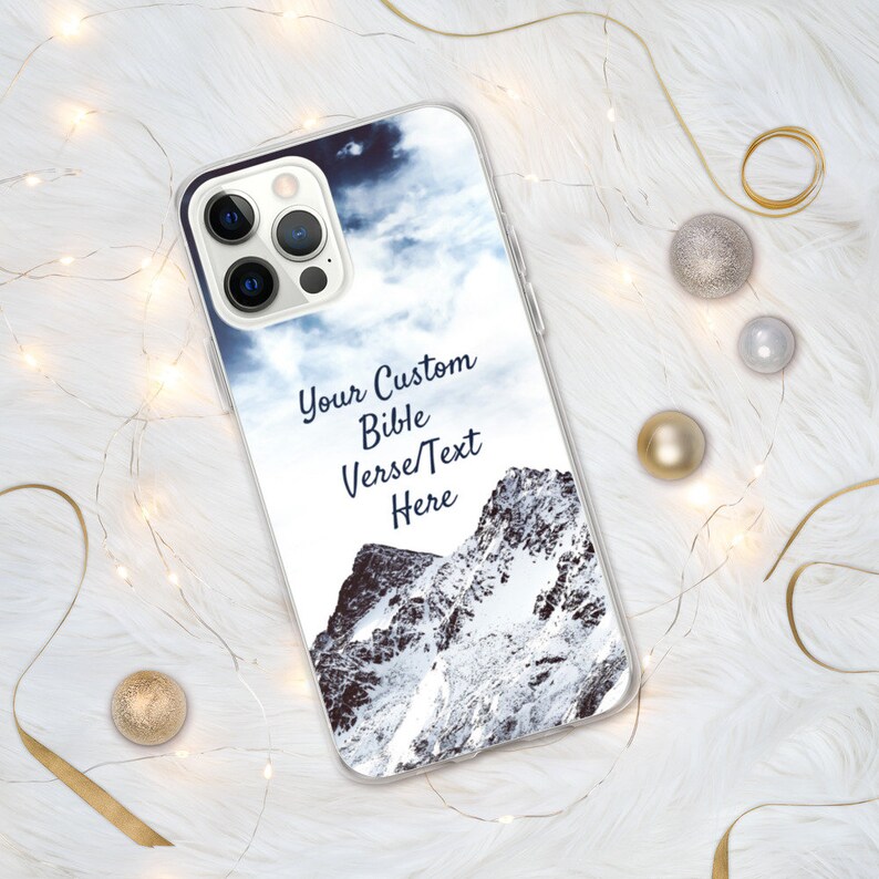 May include: A clear phone case with a snowy mountain scene and a blue sky with clouds. The text "Your Custom Bible Verse/Text Here" is printed on the case.