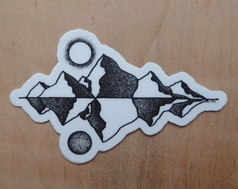 May include: Black and white sticker with a stylized image of mountains reflected in water. Two small circles represent the sun and its reflection.