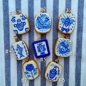 May include: A set of three ceramic mugs with a speckled, matte finish. The mugs are in shades of cream, light gray, and dark gray. Each mug has a simple, minimalist design, perfect for coffee or tea.