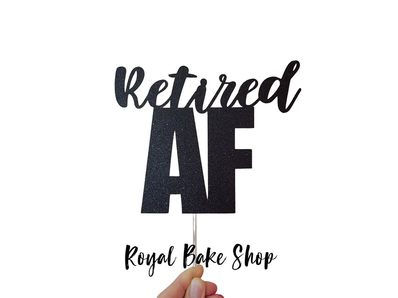 May include: Black glitter cake topper with the text "Retired AF" in a cursive font. The topper is on a stick and is held by a hand. The text "Royal Bake Shop" is visible in the bottom right corner of the image.