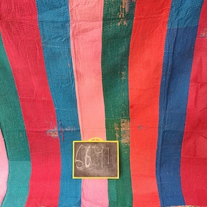 May include: A colorful striped kantha quilt with a handwritten price tag of "6691" on a chalkboard.
