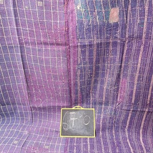 Może przedstawiać: Purpurowa i niebieska kołdra kantha z białym wzorem kratki. Kołdra ma cenę 67,90 zł napisaną na małej tablicy.