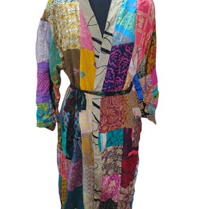 May include: A long, colorful patchwork robe with a sash tie. The robe is made of various fabrics in shades of pink, blue, green, yellow, brown, and black. The fabric is patterned with floral designs and geometric shapes.