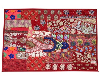 May include: A red patchwork wall tapestry with intricate embroidery and beaded details. The tapestry features a variety of floral and paisley patterns in shades of red, pink, blue, and gold.