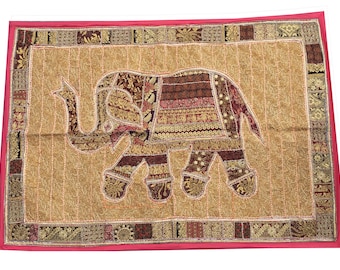 May include: A gold and brown tapestry with an embroidered elephant design. The elephant is made of various fabric scraps and has a detailed design.