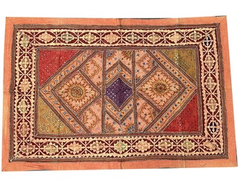 May include: A rectangular patchwork quilt with a geometric design. The quilt is made of various fabrics in shades of red, orange, yellow, and purple. The quilt is decorated with sequins and beads.