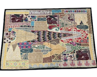 May include: A colorful patchwork wall hanging with a variety of fabrics and textures. The design features a geometric pattern with a mix of gold, red, blue, and green colors.