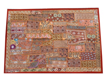 May include: A colorful patchwork tapestry with a variety of fabrics and embroidery. The tapestry is made up of many different squares and rectangles, each with a unique design. The colors are mostly warm tones, such as orange, brown, and red.