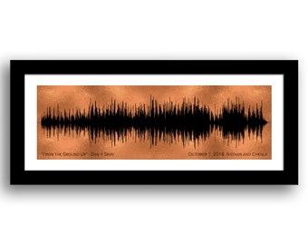 May include: A copper-colored print of a sound wave with the text "FROM THE GROUND UP" - DAN + SHAY and "OCTOBER 1, 2016 NATHAN AND CHESLA" printed below the wave.