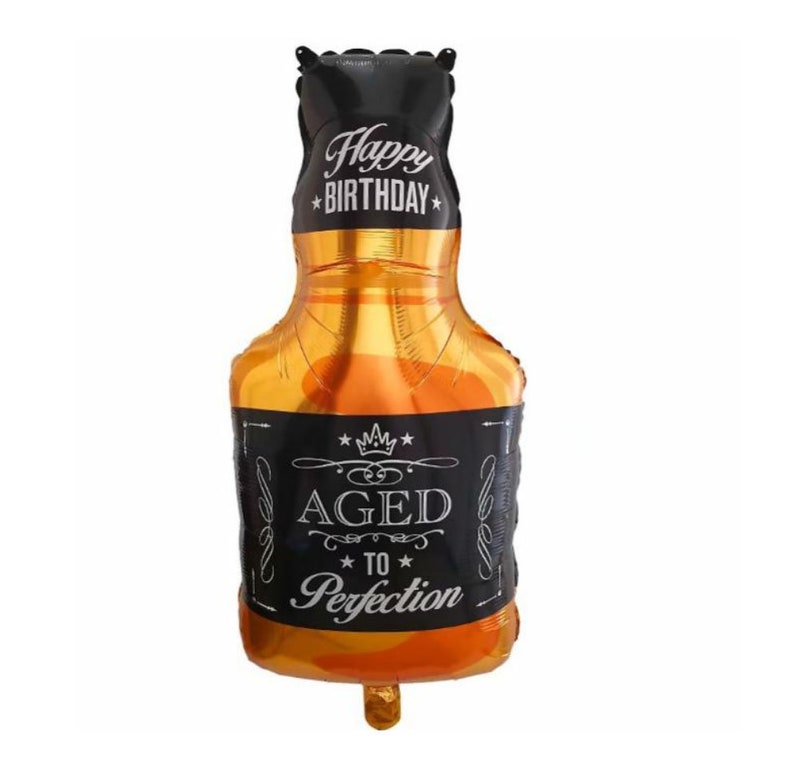 May include: A gold and black foil balloon shaped like a bottle of liquor with the text "Happy Birthday" on the top and "Aged to Perfection" on the label.