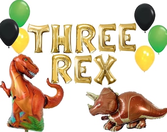 May include: Gold foil balloons spelling "THREE REX" with green, yellow, and black balloons.  There are also two dinosaur shaped balloons, one is a T-Rex and the other is a Triceratops.