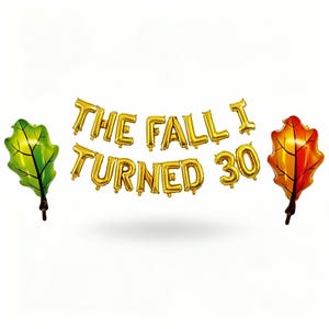 Puede incluir: Globos dorados que deletrean "THE FALL I TURNED 30" con dos globos en forma de hoja. Una hoja es verde, la otra es naranja y roja. Perfecto para una fiesta de cumpleaños con temática otoñal.