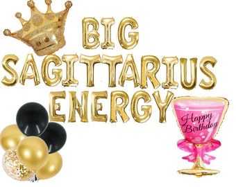 May include: Gold foil balloons spelling "BIG SAGITTARIUS ENERGY" with a gold crown and a pink cocktail glass balloon with "Happy Birthday" written on it.