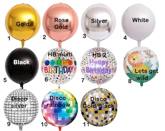 May include: A collection of eleven orb-shaped balloons in various colors and designs. Colors include gold, rose gold, silver, white, and black. Some balloons feature text that says "Happy Birthday" and "Lets get wild".