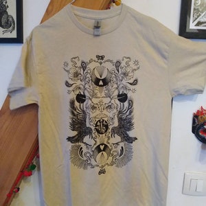 Screen-printed t-shirt. Black ink on beige/sand. Ravens gothic esoteric art occult graphic psychedelic illustrations clothing