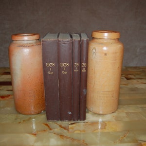 Stack of antique old books decoration old shabby dark brown books gold letters