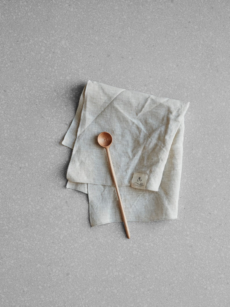 natural coloured linen napkin with a wooden spoon