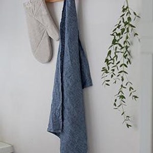 beige oven mitt hung with a blue tea towel