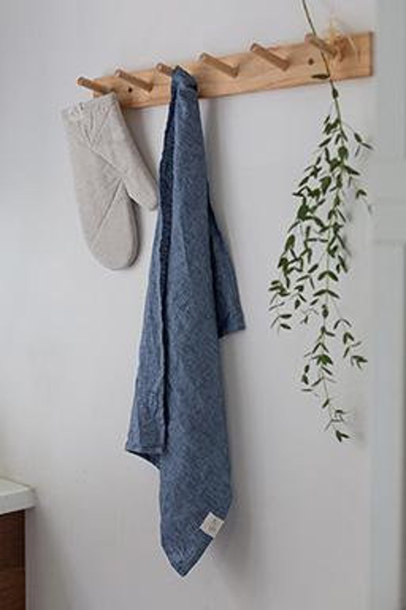 beige oven mitt hung with a blue tea towel