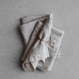 a set of four natural coloured linen napkins