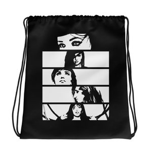 May include: Black drawstring bag featuring a black and white graphic of four women's faces in horizontal panels. The top panel shows eyes, followed by three more panels with different women's faces. The bag has black drawstrings.