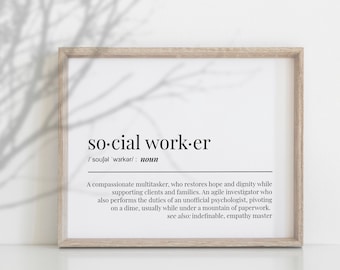 May include: A framed print with the words "social worker" in a black font. The definition of a social worker is written below the title. The frame is a light brown color.
