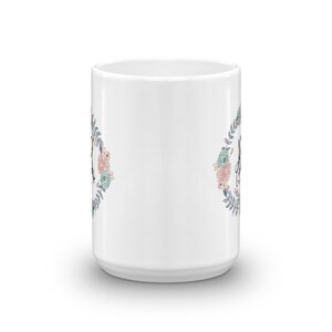 May include: White ceramic mug with a floral design and the text "Always be kind" in black lettering.