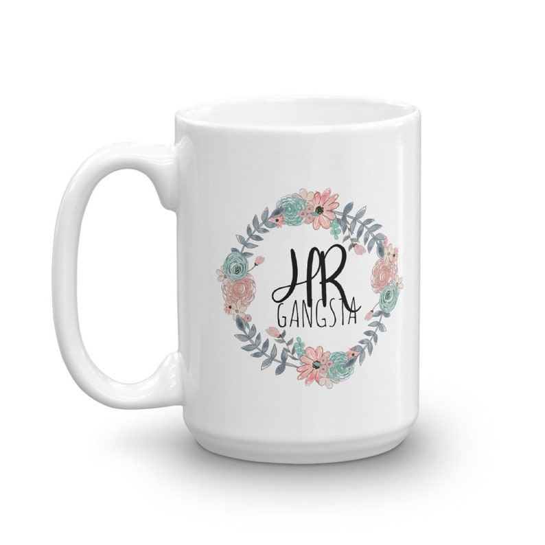 May include: White ceramic mug with a floral wreath design and the text "HR Gangsta" in black lettering.