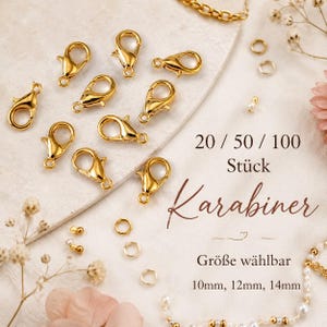 Könnte beinhalten: Eine Sammlung goldfarbener Karabinerverschlüsse und kleiner Biegeringe zur Schmuckherstellung. Der Text auf dem Bild lautet 20 / 50 / 100 Stück Karabiner Größe wählbar 10mm, 12mm, 14mm. Diese Metallteile sind übersichtlich für die Ansicht angeordnet.