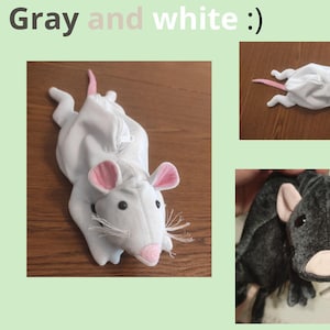 Pu&ograve; includere: Due giocattoli di peluche a forma di ratto, uno grigio e uno bianco. Il ratto grigio &egrave; sdraiato di lato con la testa rivolta verso la fotocamera. Il ratto bianco &egrave; sdraiato sulla schiena con la testa rivolta verso la fotocamera. Entrambi i ratti hanno orecchie e nasi rosa.