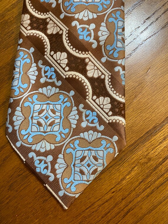 1970s  Necktie: Blue, Brown, and White Baroque medallion Pattern by Arrow
