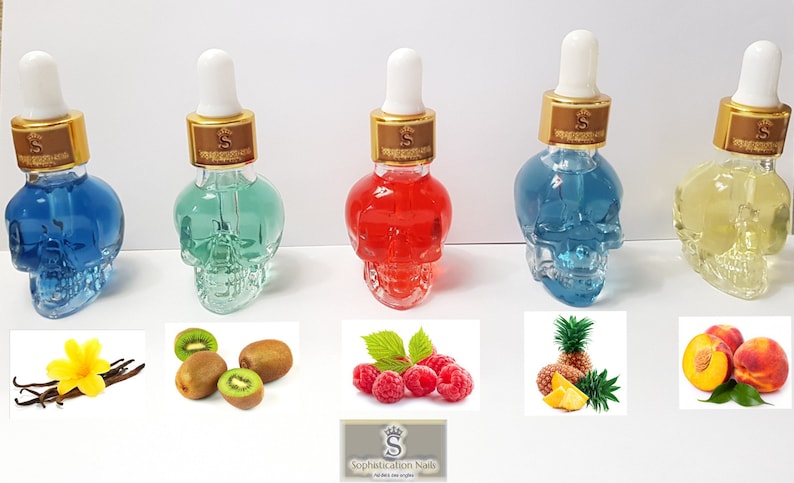 May include: Five small glass bottles shaped like skulls filled with colorful liquids. The bottles have gold lids with droppers. The bottles are arranged in a row from left to right: blue, green, red, blue, and yellow. Below the bottles are images of vanilla beans, kiwi fruit, raspberries, pineapple, and peaches.