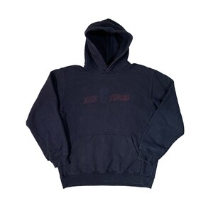 May include: A dark blue hooded sweatshirt with a red embroidered logo that says "Die  Shoes".