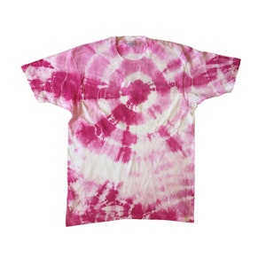 May include: A white t-shirt with a pink tie-dye pattern. The pattern is a swirl design with a darker pink center.