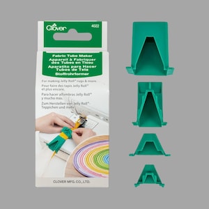 May include: Clover Fabric Tube Maker, a set of four green plastic tools for making fabric tubes. The packaging shows a colorful Jelly Roll rug and instructions for making fabric tubes in English, French, Spanish, and German.