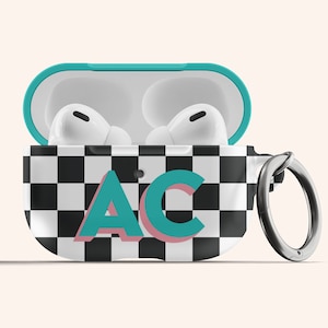 May include: A turquoise and white checkered Airpods case with a keychain and the initials "AC" in a teal and pink font.