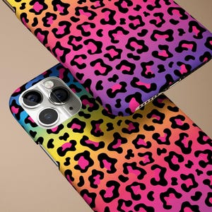 May include: A colorful phone case with a leopard print design. The case is made of a durable material and features a vibrant rainbow gradient.