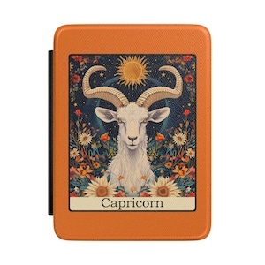 May include: Orange case featuring a Capricorn zodiac design. The artwork depicts a white goat with large horns, a golden sun, and floral elements. The word "Capricorn" is printed at the bottom of the design.