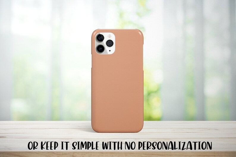 May include: A peach-colored phone case for an iPhone with a camera bump and three lenses.